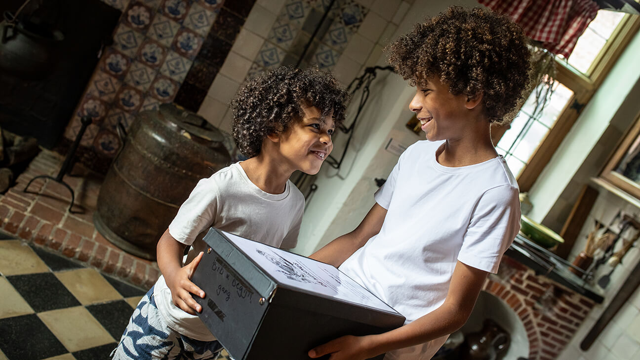 2 jongens met een schatkist in het Begijnhofmuseum Turnhout
