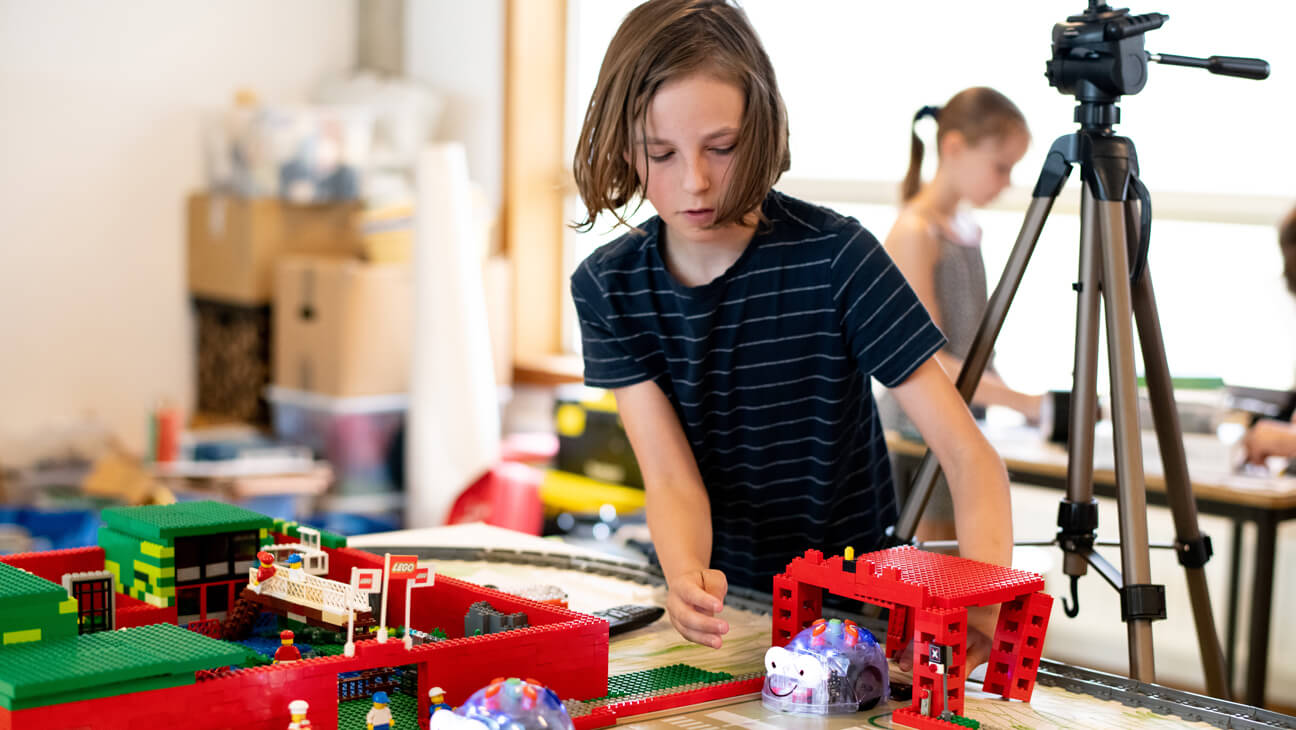 Leerling plaatst robot in Lego-stad