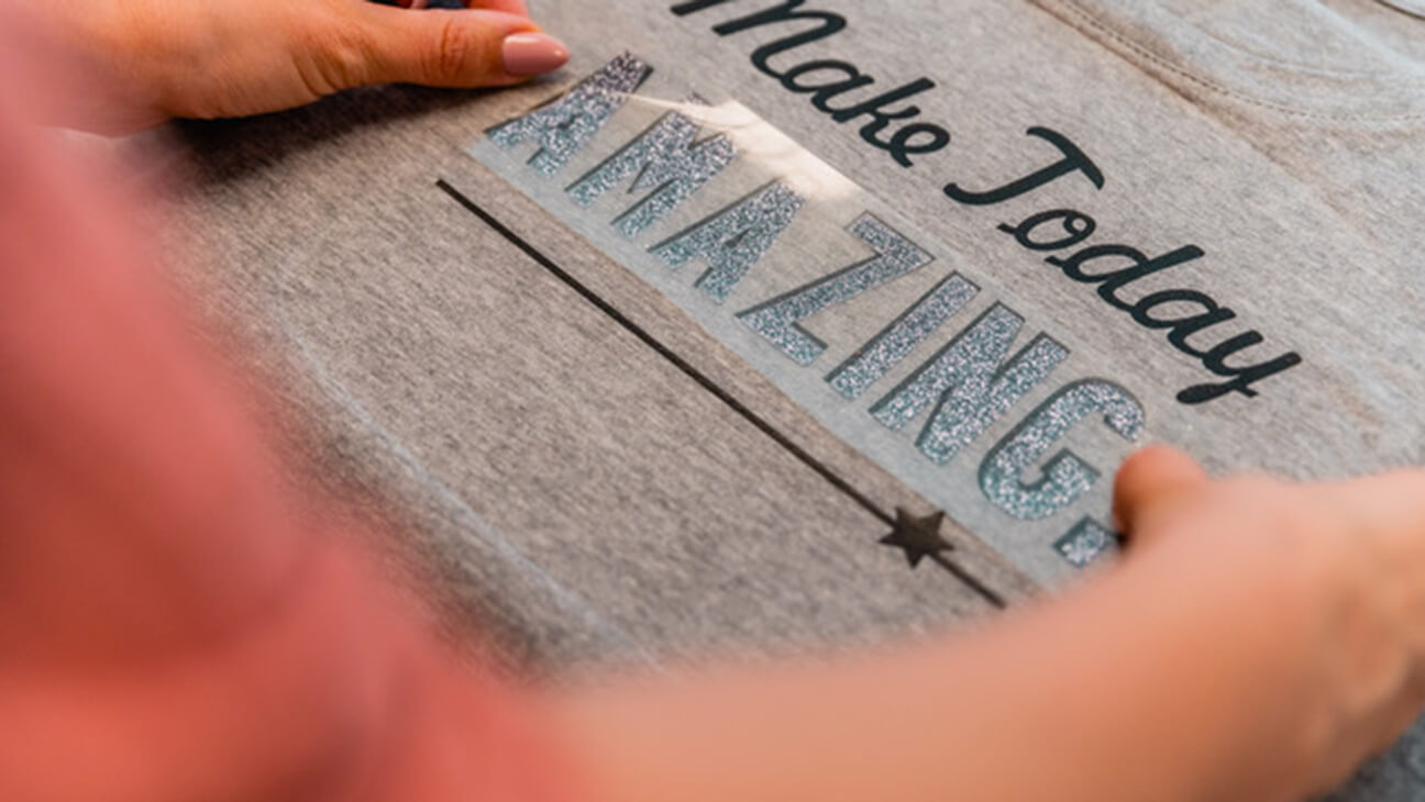 Persoon brengt belettering aan op T-shirt